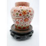 A small Chinese jar and cover, delicately enamelled with phoenix and a foliate pattern underglaze to