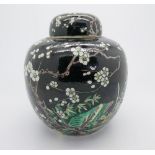 A Chinese famille verte ginger jar & cover decorated with blossom foilage, on black ground, - six