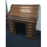 An American mahogany roll top desk by the Indianapolis Cabinet Company, the tambour closing top