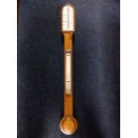 A Victorian oak stick barometer by TB Winter of Newcastle, having arched ivory gauge under