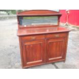 A late Victorian mahogany mirror back chiffonier, the arched back above a moulded shelf, having