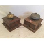 Two cased railway bell units, the cabinets on moulded plinths surmounted by brass bells. (2)