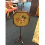 A Victorian mahogany pole screen, the octagonal frame with floral woolwork tapestry panel on pole