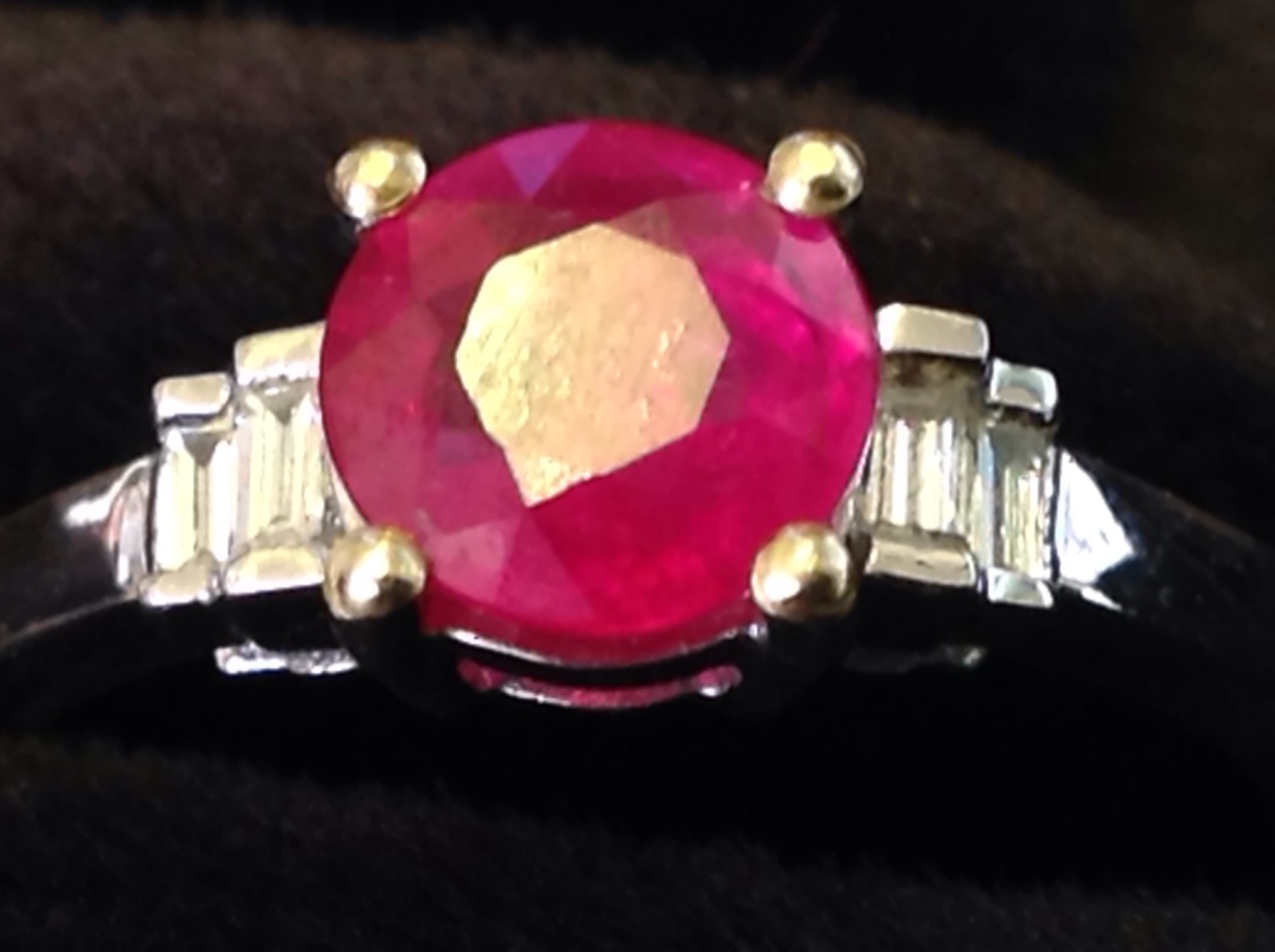 An 18ct gold ruby & diamond ring, the circular claw set ruby weighing three-quarters of a carat, - Image 2 of 3