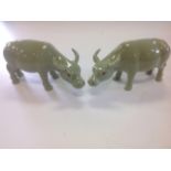 A pair of Chinese oxen, the animals with celadon glaze having black eyes and shaped horns. (6.5in)