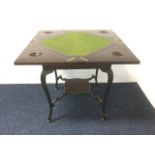 An stained Edwardian envelope card table, having baize lined interior with counter wells, above