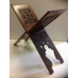 A carved oriental book stand, the folding hardwood piece having pierced rectangular panels above