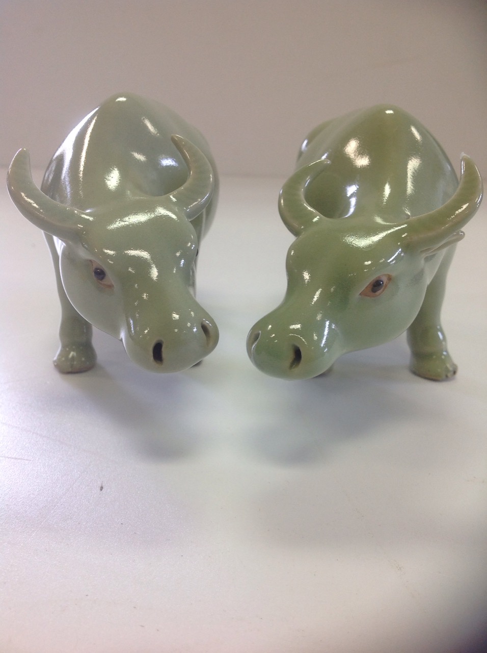 A pair of Chinese oxen, the animals with celadon glaze having black eyes and shaped horns. (6.5in) - Image 2 of 3