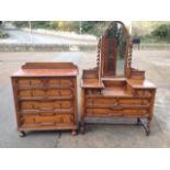 A Jacobean style oak dressing table & chest of drawers, the dressing table with arched bevelled