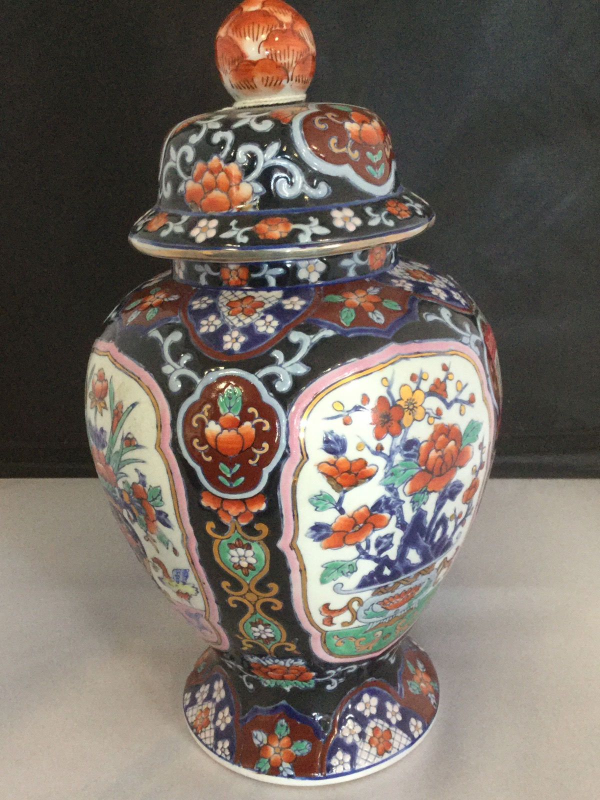 A Cantonese Imari style lidded jar with matching tapering vase, decorated with floral panels of - Image 2 of 3