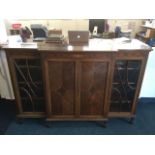 An Edwardian breakfront mahogany cabinet, the top with chevron inlaid band above a frieze