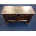 A small eighteenth century oak coffer, the box with twin panelled front beneath a chisel carved