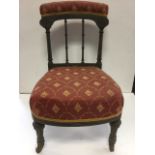 A Victorian ebonised side chair, with upholstered back rail having gilt scrolled decoration