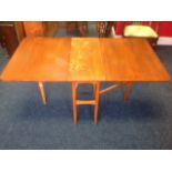 A rectangular mahogany drop-leaf dining table, having long rounded flaps with gates, supported on