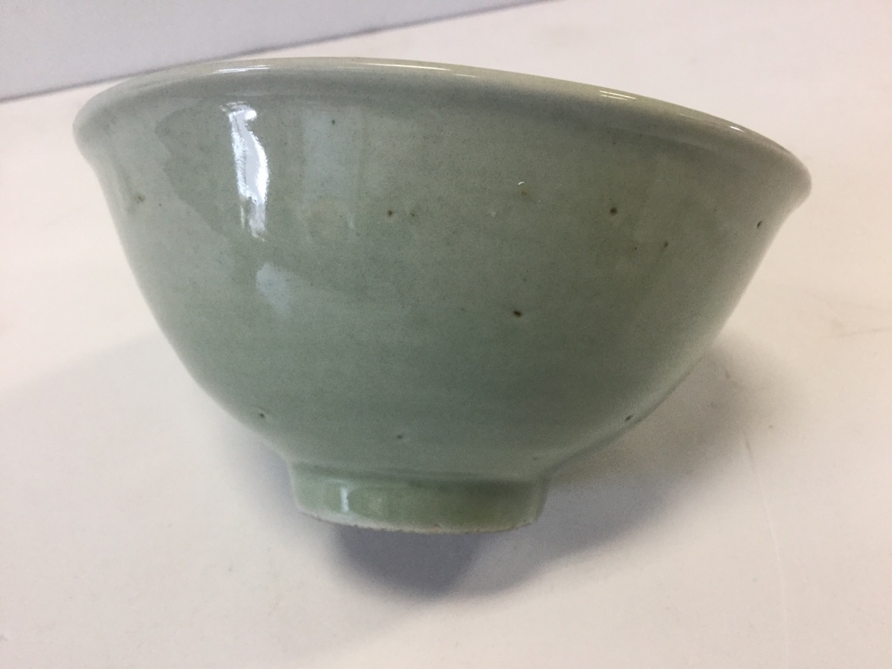 A pair of early Chinese celadon glazed bowls, raised on tubular bases, unmarked and one - Image 2 of 3