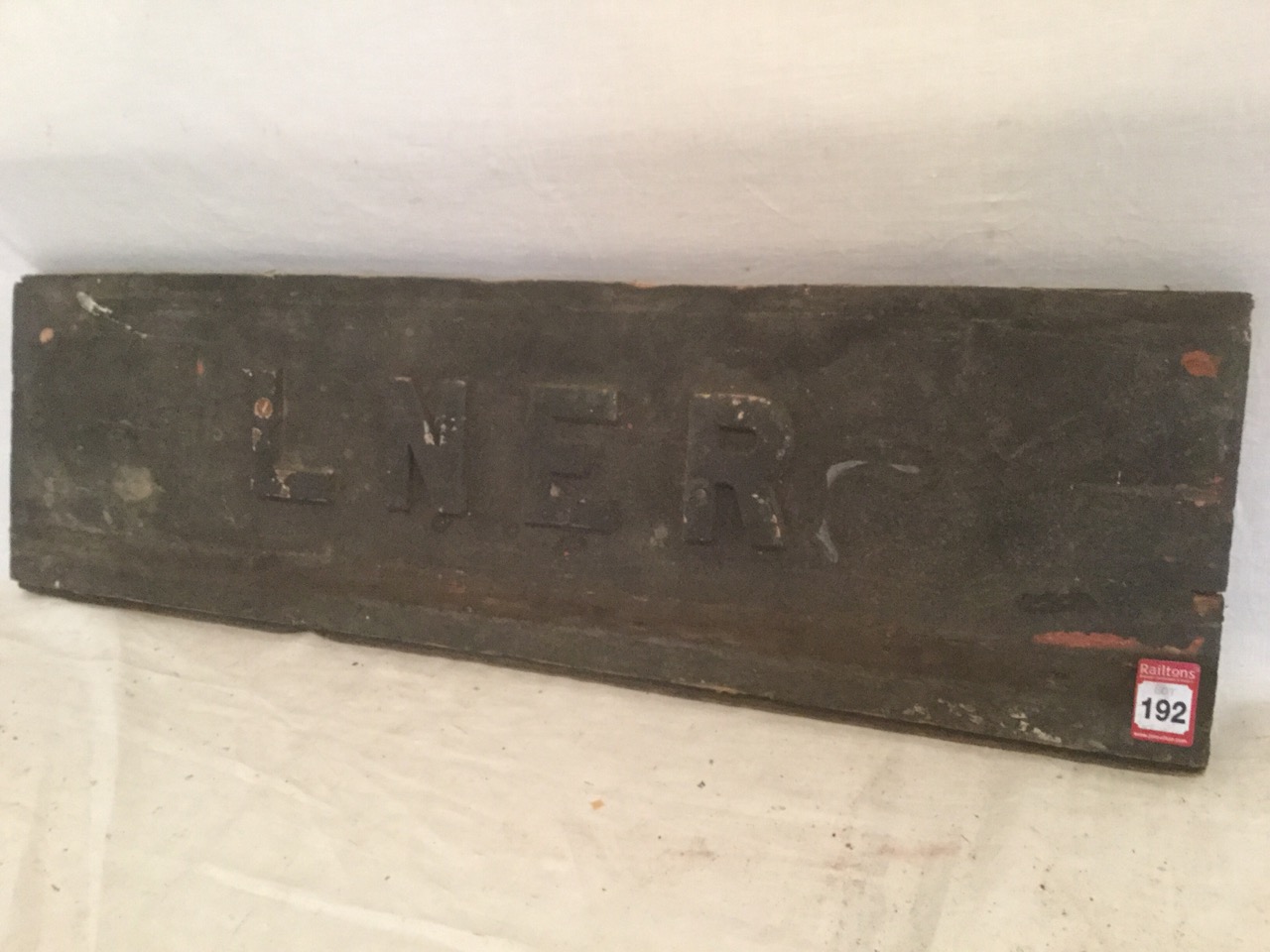 A rectangular wood sign, LNER with raised lettering. (28in)