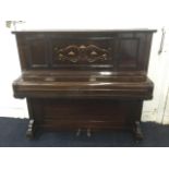 A stained art nouveau upright piano by TG Payne, the panelled case inlaid with scrolled copper &