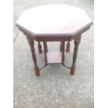 An Edwardian octagonal walnut occasional table, the moulded top raised on eight ring-turned