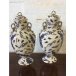 A pair of oriental style vases & covers of ovoid form, mounted with gilded ribbon handles, all-