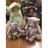 Two Leonardo porcelain headed dressed dolls on stands; and a graduated set of four plush teddies. (