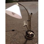 A Daylight Company tablelamp, the circular stand with compartments supporting a reading lamp, a