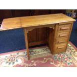 An oak desk, with drop flap to rectangular moulded top, the panelled kneehole with carved