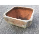 A handmade terracotta plant pot, the square planter with moulded cut corners.