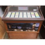 A 70s NSM jukebox, the machine loaded with singles from the era, the cabinet with hardwood grill