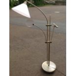 A Daylight Company reading light, the circular weighted stand on casters supporting lamp with shade,