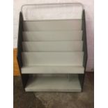 A contemporary card rack, the graduated display stand on casters.