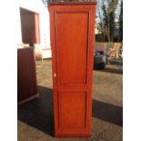 A single mahogany wardrobe, the panelled door mounted with brass knob enclosing hanging space.