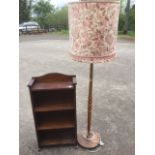 A small open bookcase with arched back above four shelves, raised on block feet; and a 70s teak