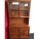 A mahogany dresser by Nathan Furniture, having arched glazed doors enclosing shelf above an open