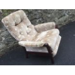 An upholstered reclining armchair with button back on wood frame, having rising footrest.