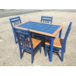 A kitchen table & chair set, the table with tiled top supported on rectangular rounded legs, the