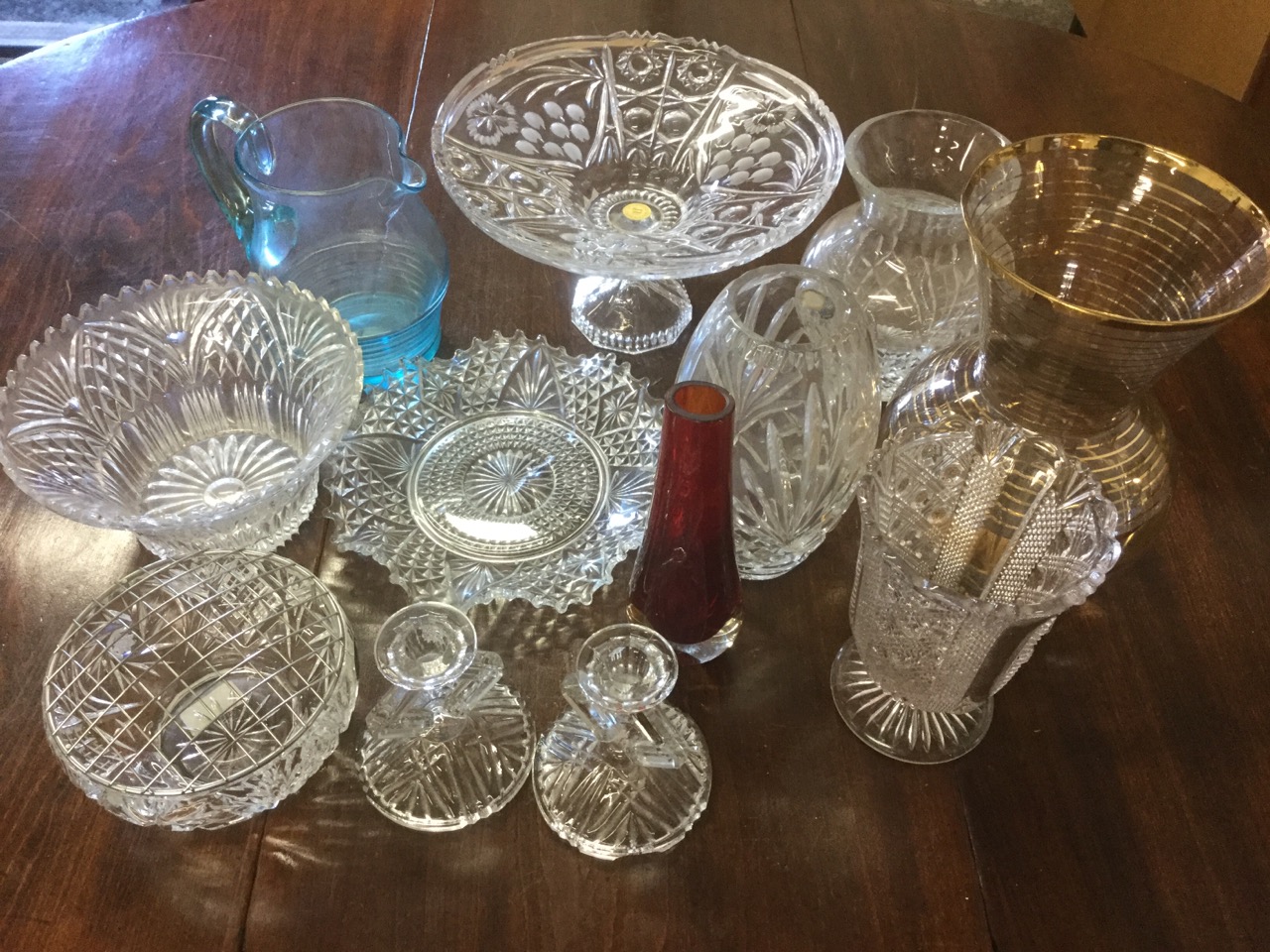 A quantity of glass including vases, a pale blue jug, a large gilt flared vase, a pair of