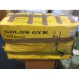 A boxed Golds Gym X-train fitness machine.