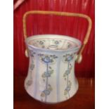 An art nouveau style Staffordshire slop pale and cover, the bucket with cane swing handle, decorated