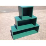 A set of three graduated green painted wood boxes or stands. (3)