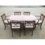 A regency style mahogany dining room suite, the crossbanded table with spare leaf raised on twin