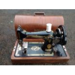 A walnut cased Singer sewing machine with gilt decoration.
