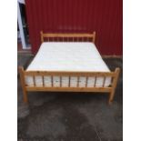 A pine double bed, having turned spindled head & tailboard with slatted base, fitted with a