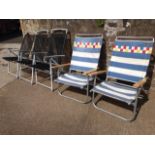 A set of three folding garden armchairs on tubular frames; and a pair of chairs with aluminium