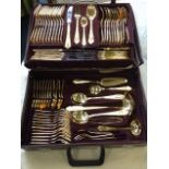 A cased canteen of gilded cutlery, the 12 settings with foliate scrolled handles - marked 23/24