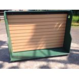 A green painted shop display cabinet having rectangular moulded top above a grooved hanging board,