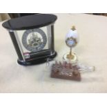 A black Mattel clock with Roman numerals and minute movement; a Mary-Rose ship in a bottle with