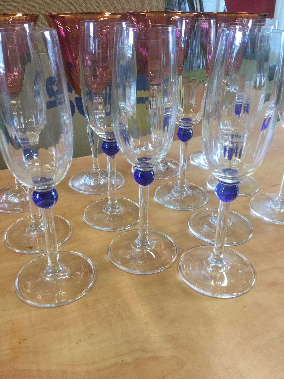 A set of nine champagne flutes on slender stems with blue bead decoration; and four large wine - Image 6 of 6