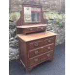 A stained late Victorian dressing table, with bevelled mirror above two small drawers and shelf, the