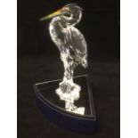 A Swarovski heron on reed base, complete with mirrored stand, modelled with yellow beak and black