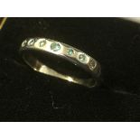 A platinum ring set with seven blue stones - untested.